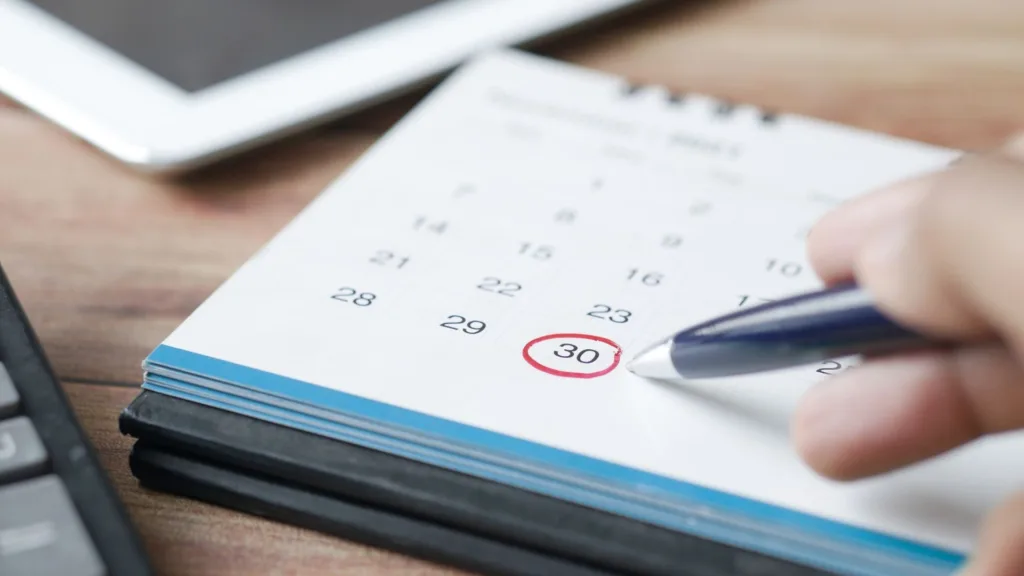 Någon antecknar in sin kalender. Datumet den 30 är inringat i rött.